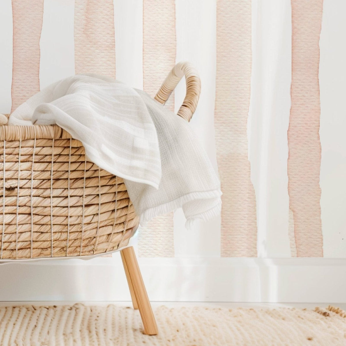 Watercolor Stripes Pink nursery wallpaper styled in a baby's room