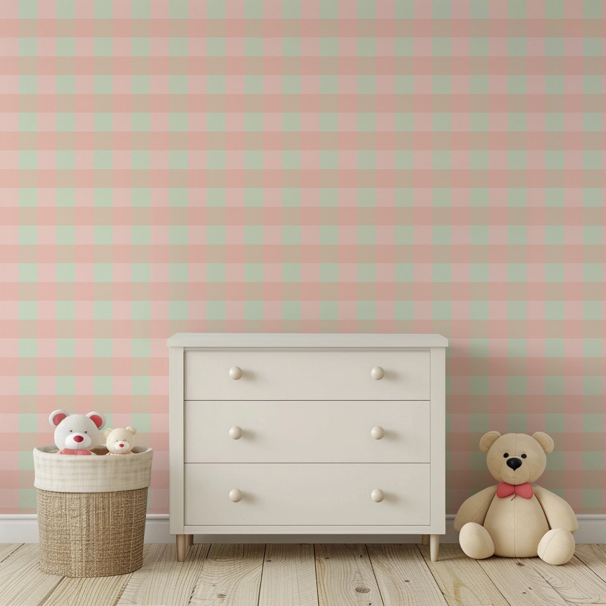 Blush and mint check wallpaper behind a white chest of drawers and a teddy bear