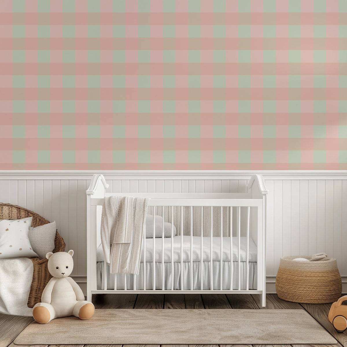 Blush, mint and sandy tan check wallpaper above white panelling behind a white cot