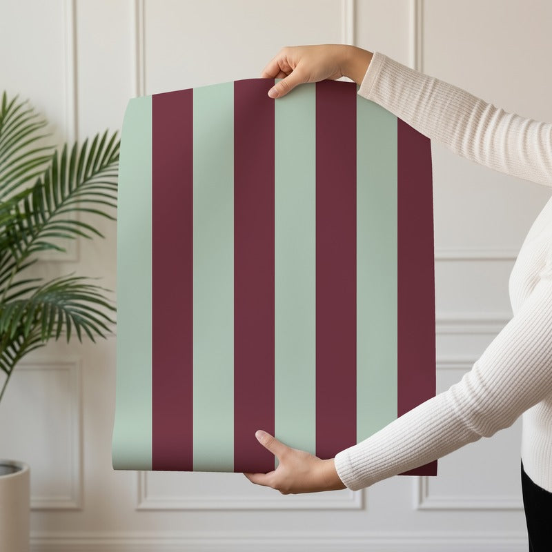 Classic Stripe Wallpaper roll in Mineral Mint & Oxblood – bold stripes on an oxblood ground