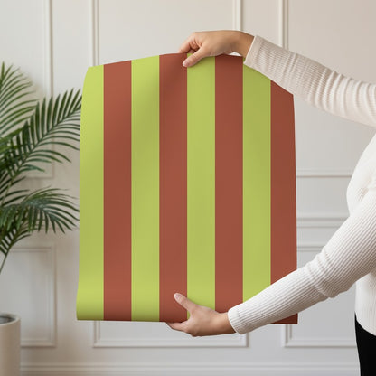 Classic Stripe Wallpaper roll in Soft Chartreuse & Burnished Rust – bold stripes on a burnished rust ground