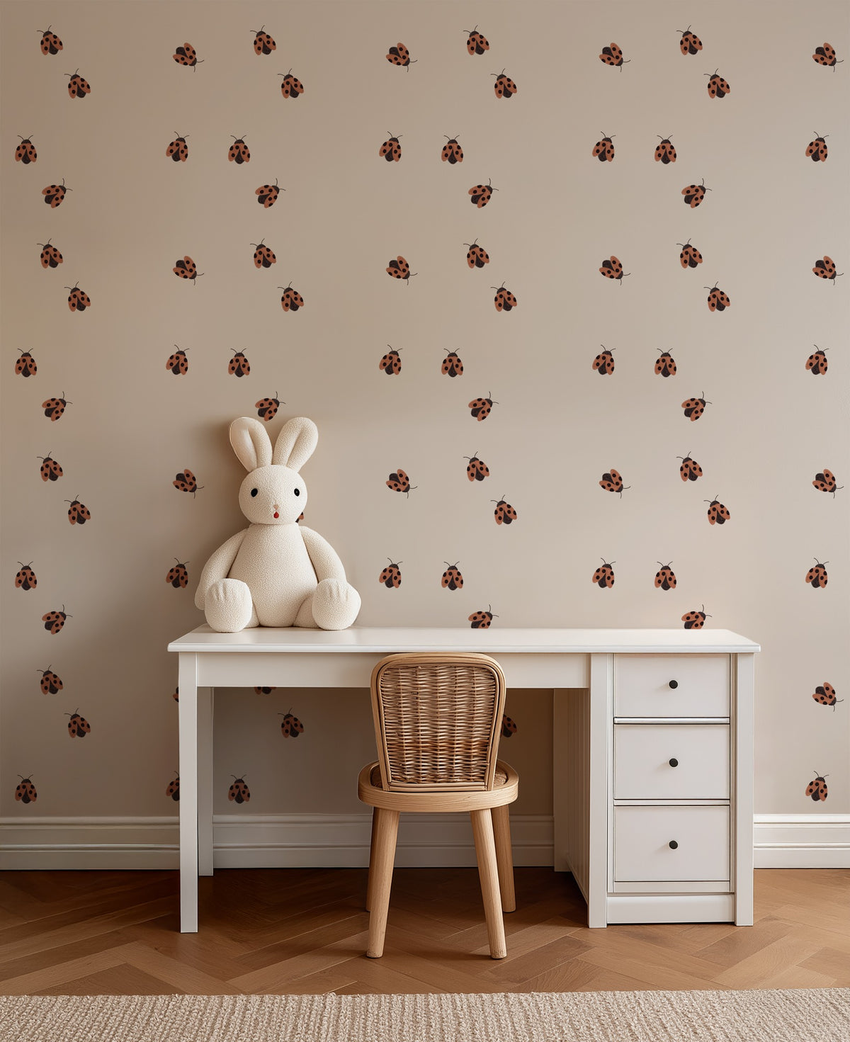 Ladybugs wallpaper behind a child's desk in a playful study corner