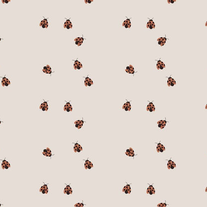 Ladybugs wallpaper design — tiny hand-painted red ladybugs scattered on a warm oat ground
