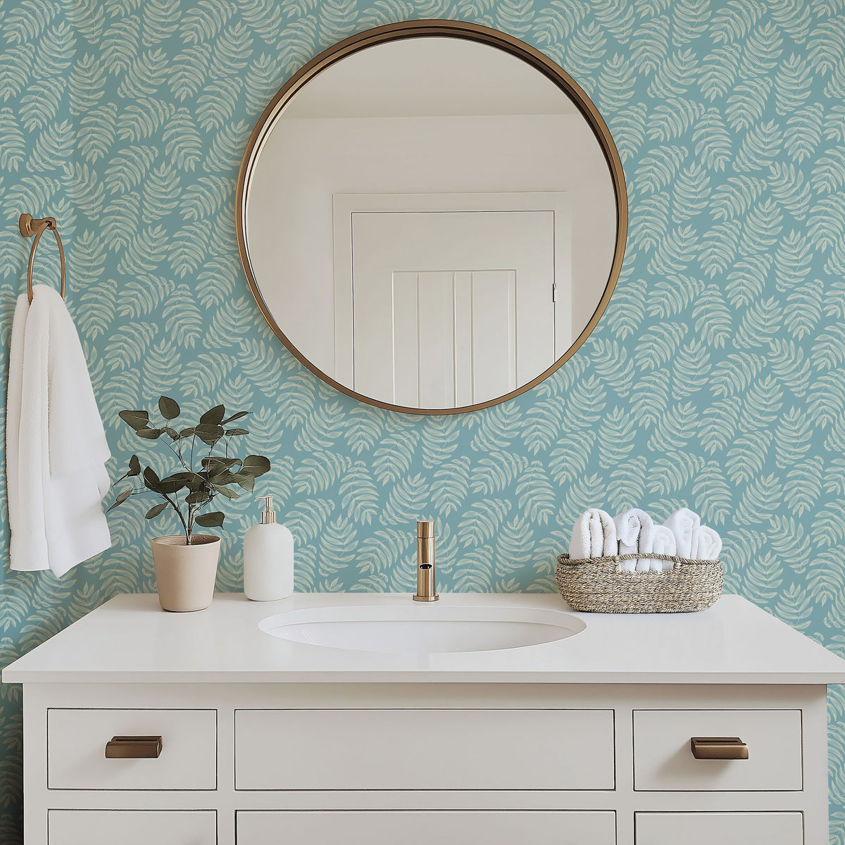 Laguna tropical palm frond wallpaper in a bright bathroom with white fixtures