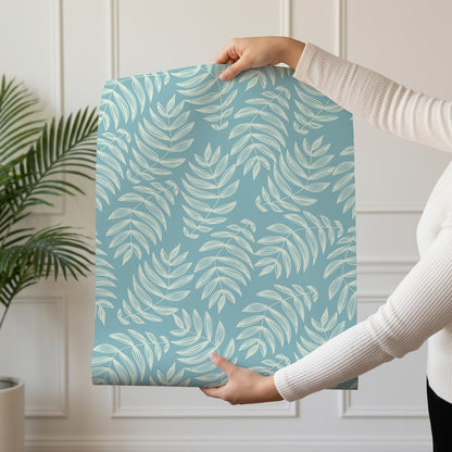 Laguna wallpaper roll drop showing the aqua palm frond repeat on lagoon blue