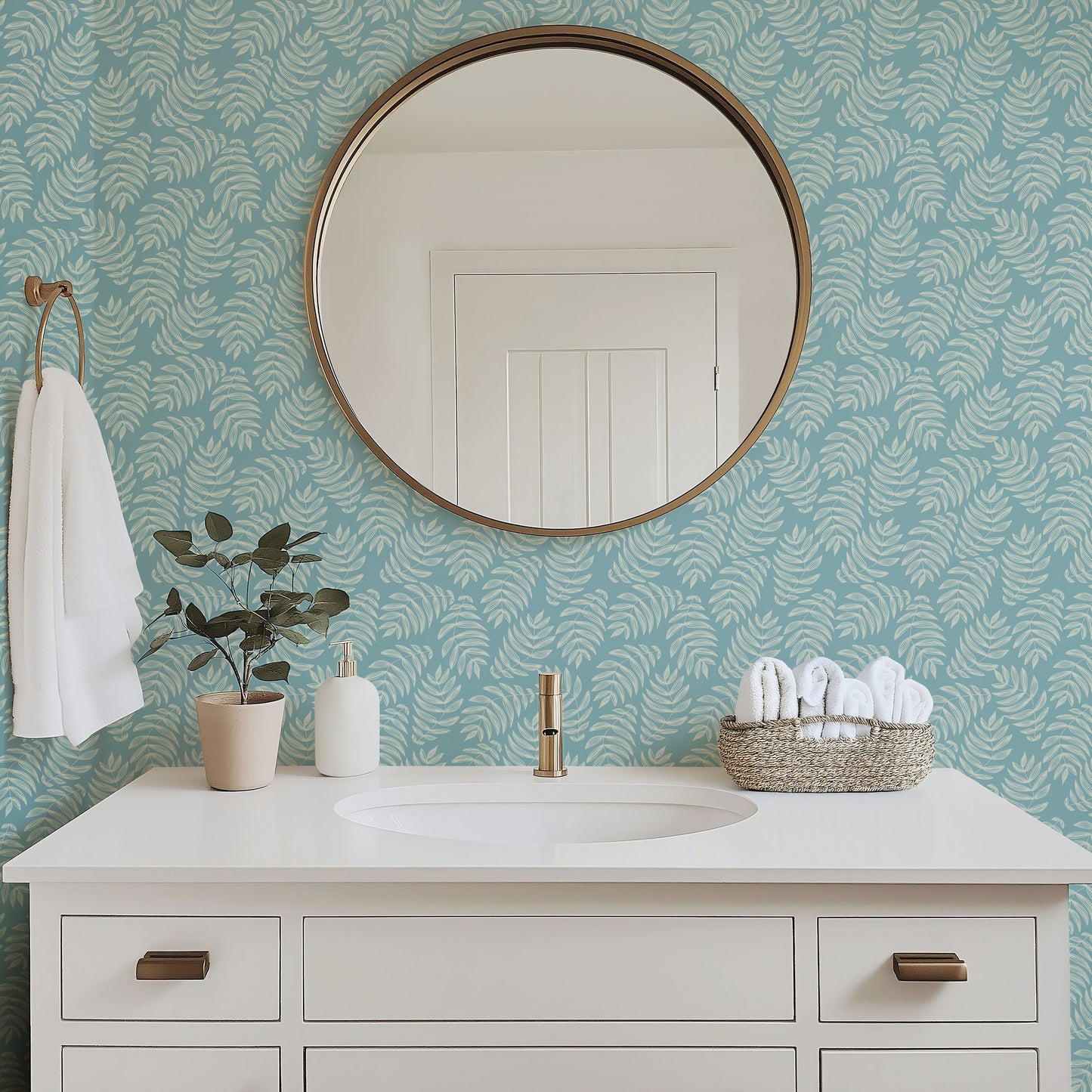 Laguna tropical palm frond wallpaper in a bright bathroom with white fixtures
