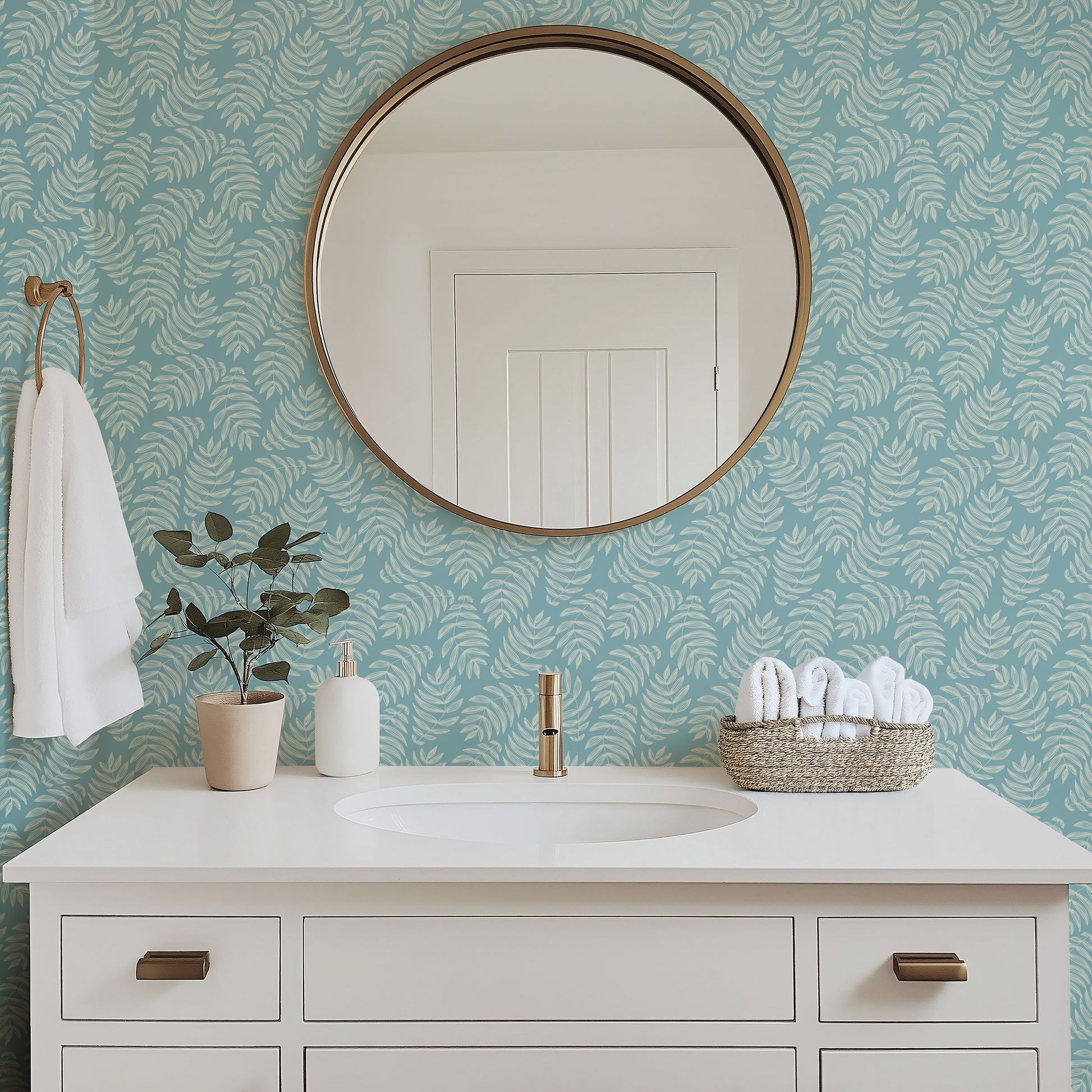 Laguna tropical palm frond wallpaper in a bright bathroom with white fixtures