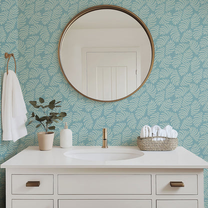 Laguna tropical palm frond wallpaper in a bright bathroom with white fixtures
