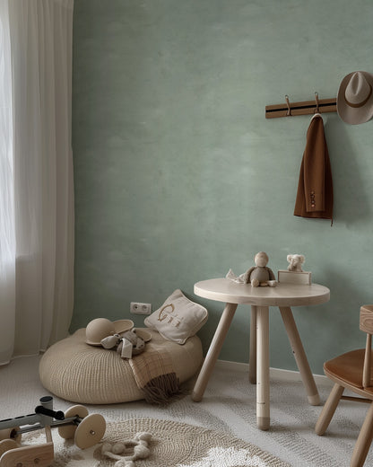 Limewash Sage textured green wallpaper in a soft nursery