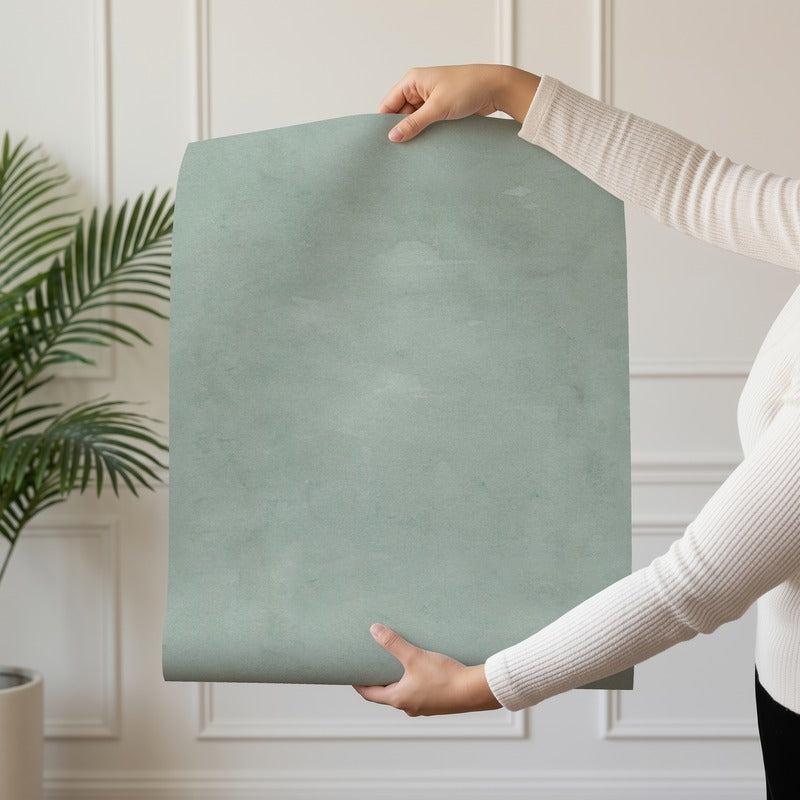 Limewash Sage wallpaper roll drop showing the textured sage finish