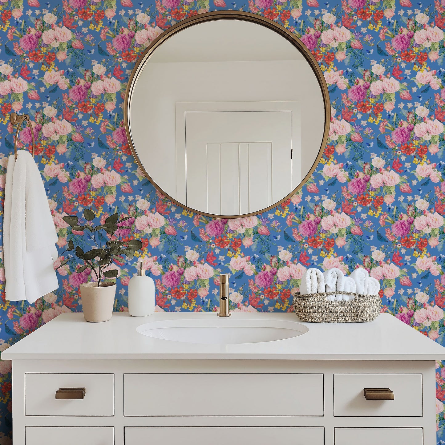 Mazzolino pink and blue floral wallpaper in a bright bathroom with white fixtures