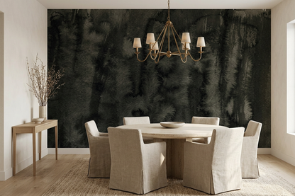 Nocturne Reed mural behind a round pale-stone dining table with slipcovered linen chairs