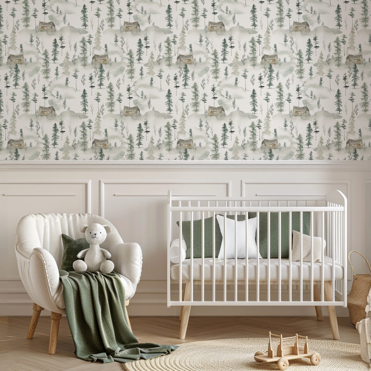 Pineta watercolour pine forest wallpaper in a nursery with a white cot and boucle armchair