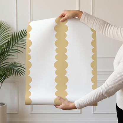 Scalloped Stripes Honey wallpaper roll drop showing the honey-gold scalloped pinstripe repeat
