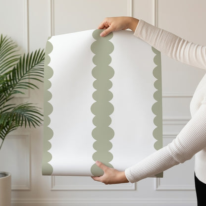 Scalloped Stripes Sage wallpaper roll drop showing the sage-green scalloped pinstripe repeat
