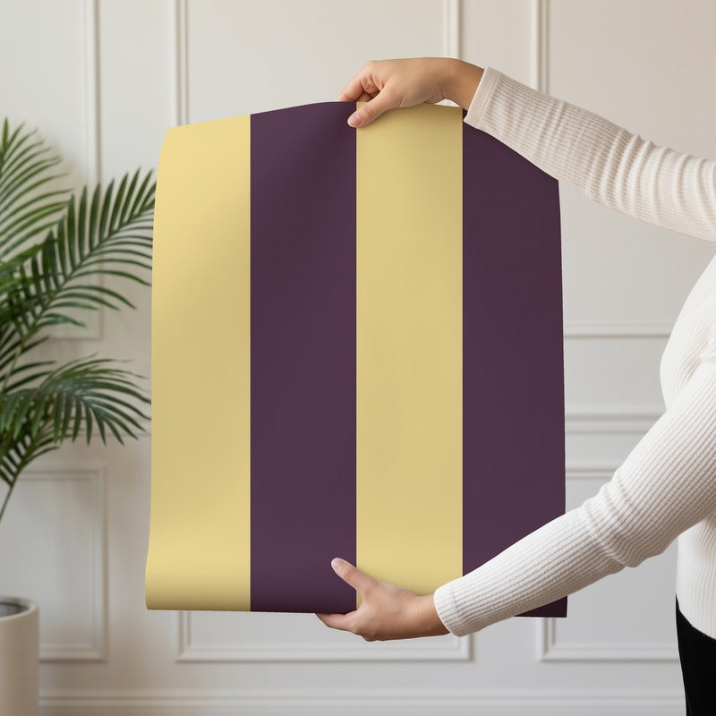 Wide Stripe Wallpaper roll in Butter & Aubergine – graphic, wide stripes on an aubergine ground