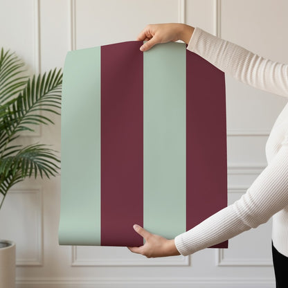 Wide Stripe Wallpaper roll in Mineral Mint & Oxblood – graphic, wide stripes on an oxblood ground